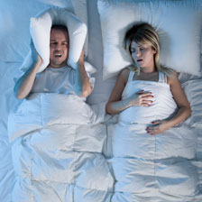 Snoring couple in bed
